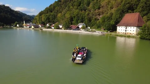 Small car and bicycle ferry crossing the Danube in Upper Austria Stock Footage 342427217