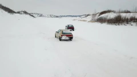 Small car drives by snowbound track not far from 库存影片 299632962