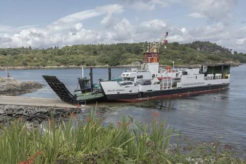 Small Car Ferry docking at Tarbert with cars and vans onboard Stock Photos