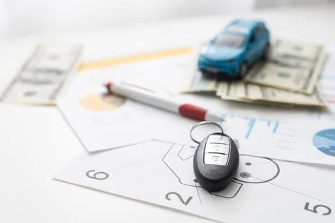 Small car model and blueprint sheets. Foto stock