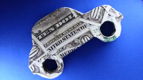 Small car model with dollar banknote on blue background Video stock 250438115