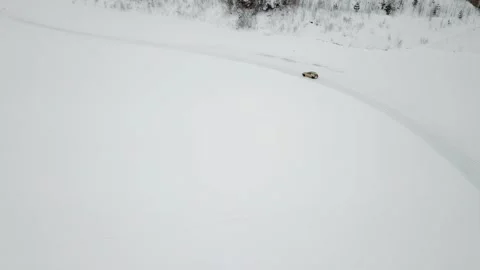 Small car rides by snow covered track, not far 库存影片 299634404