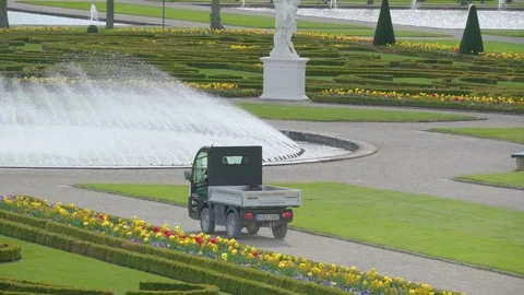 A small car running on the lawn outside Stock Footage