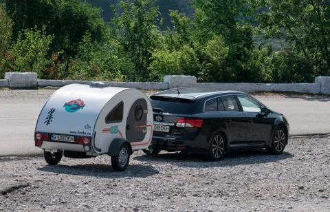 Small caravan pulled by the car. Stock Photos