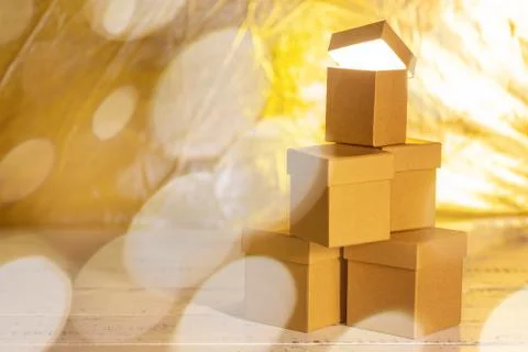 Small cardboard gift boxes with bokeh effect as concept of christmas sale. Stock Photos