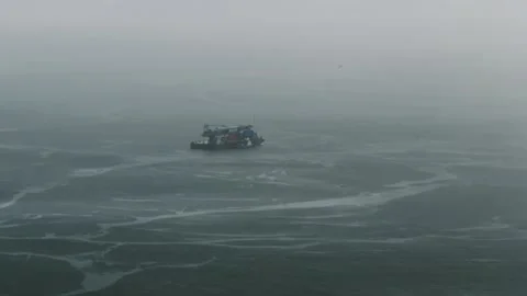 Small cargo boat navigating through dense misty fog Stock Footage 345009603