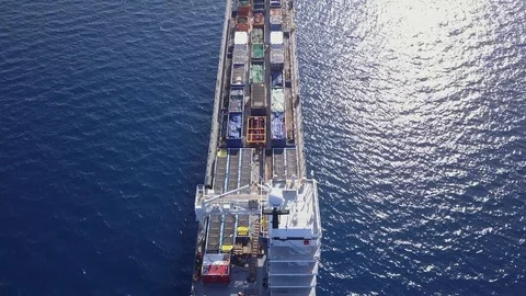 Small Cargo Ship loaded with colourful Containers and large crates. Stock Footage 125079444