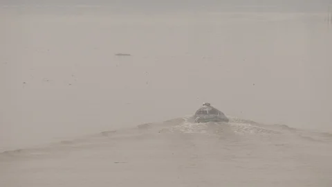 Small cargo ship passing through the river that covered by smoke Stock Footage 121647414