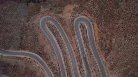 Small cargo truck going on the U-turn in the mountains. Aerial top down view Video stock 168255578
