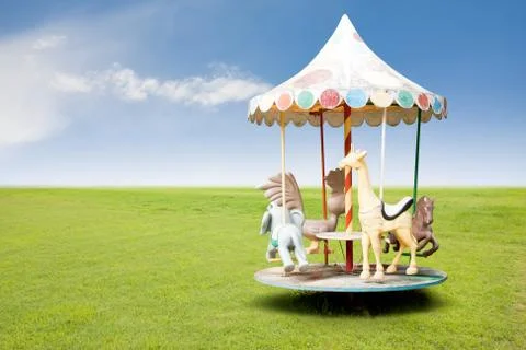 Small carousel on grass field Stock Photos