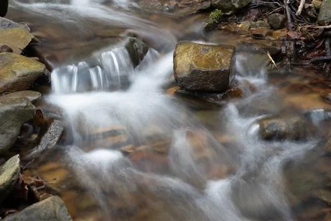 Small cascade on mountain stream Stock Photos