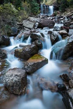 Small cascade under larger waterfall on creek in Colorado. Stock Photos