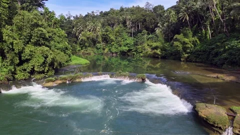 Small Cascading Waterfall Surrounded by Tropical Forest Scenery Stock Footage 295792966
