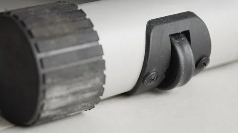 Small caster wheel providing mobility to a durable grey and black object 库存影片 335022555