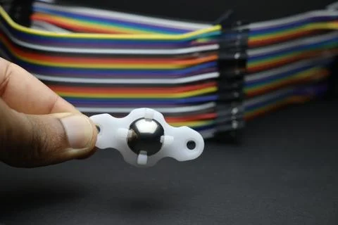 Small caster wheel used in robotic diy projects held in hand Stock Photos
