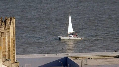 Small catamaran passing Praca Commercia Lisbon Stock Footage 119056134