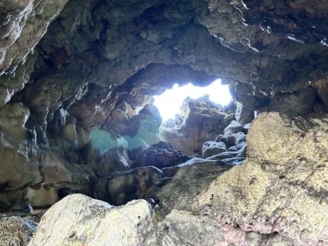 A small cave on the coast Stock Photos
