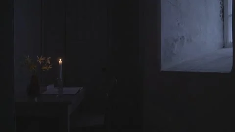 Small cell, tiny bare basics living quarters with candle Stock Footage 130281824