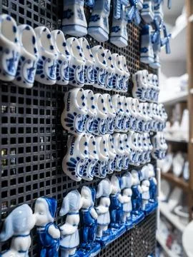 Small ceramic clogs on rack for sale to tourists in a souvenir shop Fotos Stock