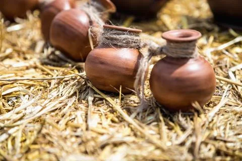 Small ceramic crocks or pot on straw Stock Photos