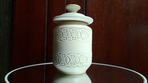 A small ceramic object resembling a lidded cylinder Stock Footage 341308205