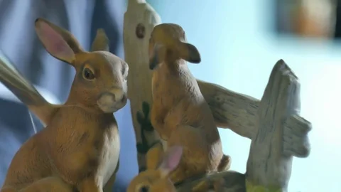 Small ceramic rabbits being dusted with a paint brush. Color corrected version. Stock Footage 72766300