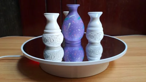 A small ceramic vase featuring colorful circular motifs Stock Footage 341309175