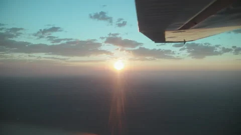 Small Cessna airplane smooth flying at 10,000 feet during sunrise. Stock Footage 164336140