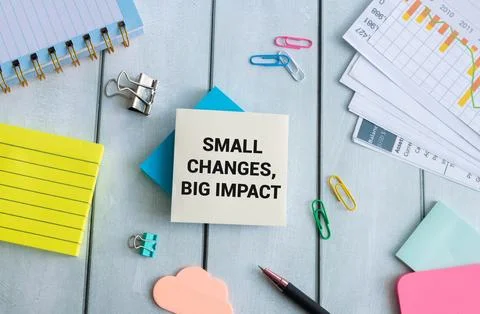 Small Changes, Big Impact text on paper card with alarm clock. Stock Photos