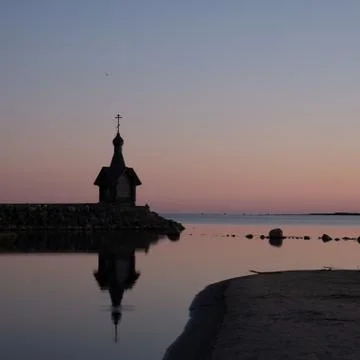 A small chapel in the background of the sunset. Stock Photos