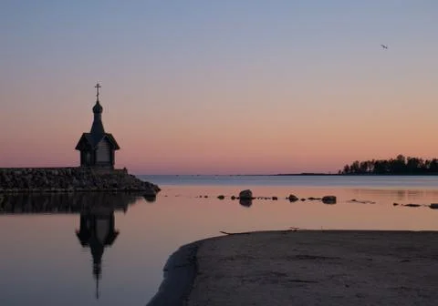 A small chapel in the background of the sunset. Stock Photos