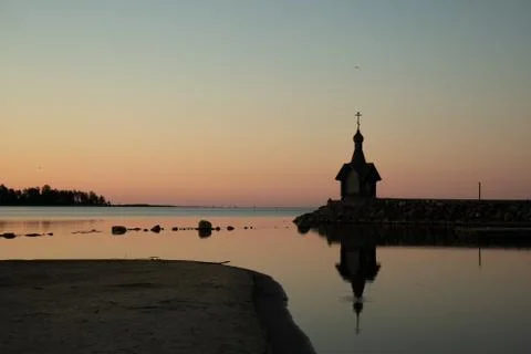 A small chapel in the background of the sunset. Stock Photos