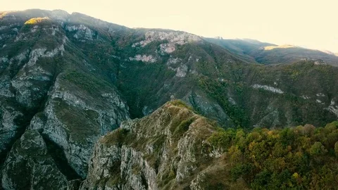 A small chapel on the mountain edge against at the morning. Aerial shot Video stock 81635173