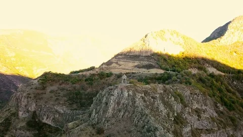 A small chapel on the mountain edge against at the morning. Aerial shot Stock Footage 81636426