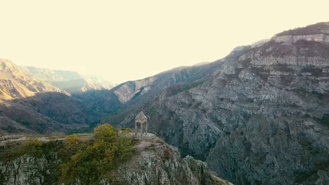 A small chapel on the mountain edge against at the morning. Aerial shot Video stock 81637195