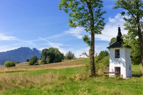 Small chapel with mountains in the background. Stock Photos