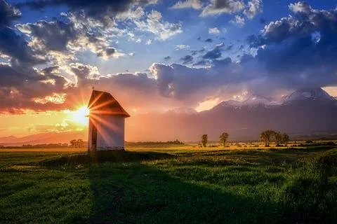 Small chapel at sunset in summer with the rays of the sun Stock Photos