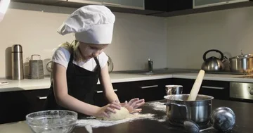 A small chef prepares a pie in the kitchen. Stock Footage 85829302