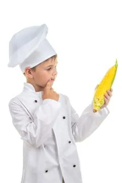 Small chef thinking of what dish he could make with corn, isolated on white Stock Photos