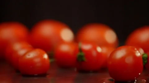 A small cherry tomato spins, forming waves around itself. Stock Footage 269930282