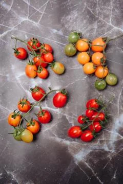 Small cherry tomatoes on a granite background Stock Photos