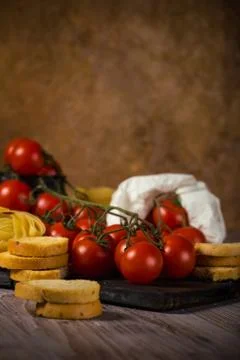 Small cherry tomatoes on several twigs with bruschetta Stock Photos