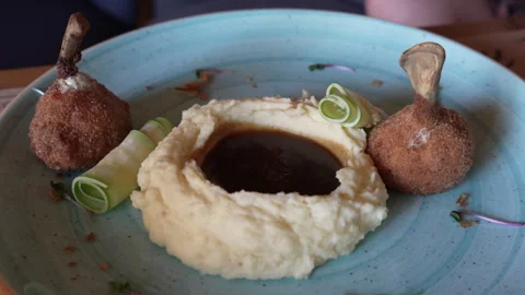 Small chicken Kiev with mashed potatoes and sauce Stock Footage 248541558