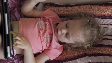 Small child 3 years old playing with a tablet Stock Footage 139592807