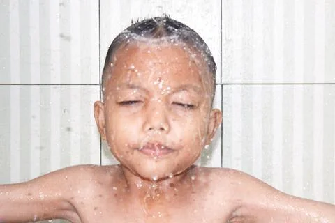 A small child is bathing in the bathroom Фото