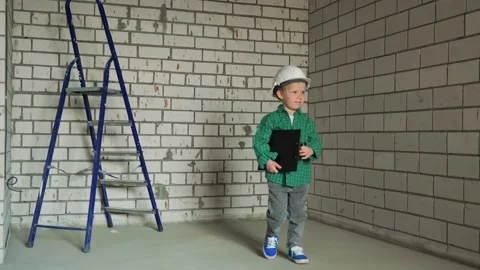 A small child boy checks his future room at the construction site Stock Footage 238394884