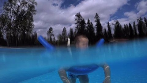 A small child, a boy floats on a stick for bathing 動画素材 111413983