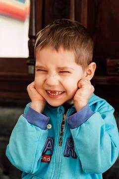 Small child boy without front teeth angry Stock Photos