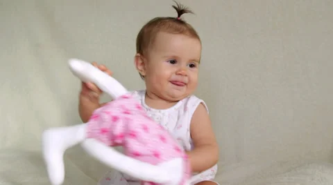 Small child cheerfully plays Stock Footage 32709437