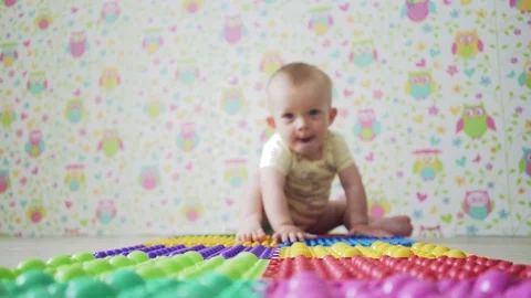 A small child crawling on orthopedic Mat Stock Footage 76605274